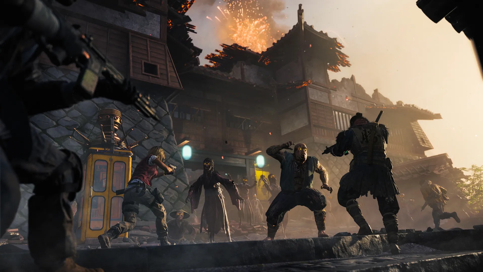 Official Tenshu Survival still — operators fighting glowing-eyed zombies at a burning Japanese fortress with a yellow phone booth
